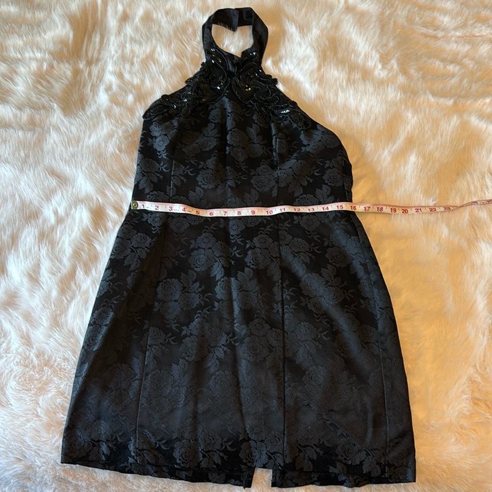 Black halter dress with sequined neckline.